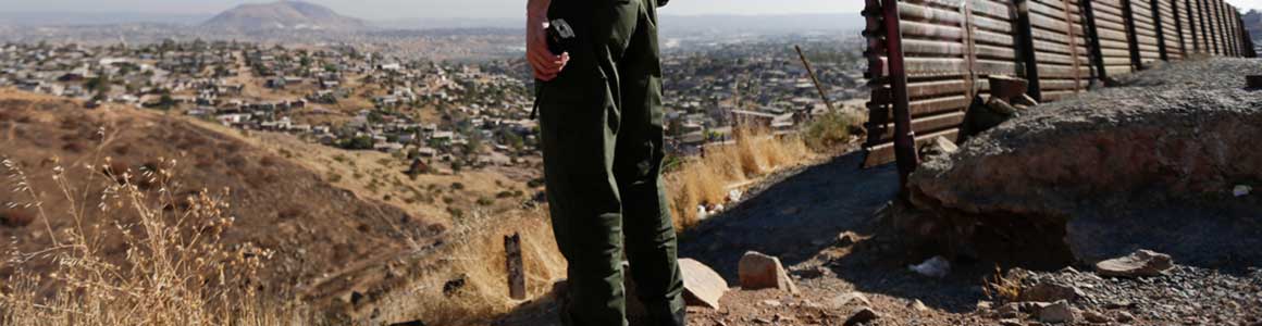 Image of border patrol officer looking out across the border