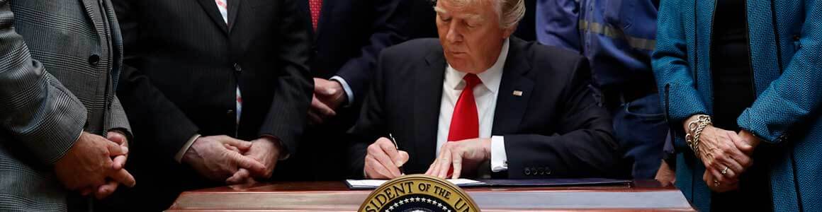 Image of President Trump signing legislation