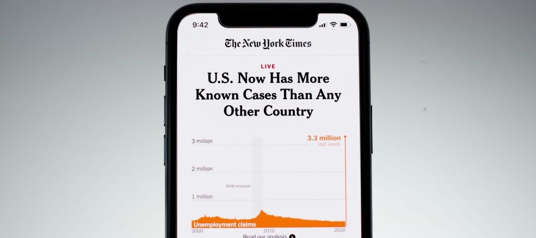 Cell phone displaying news article regarding COVID cases