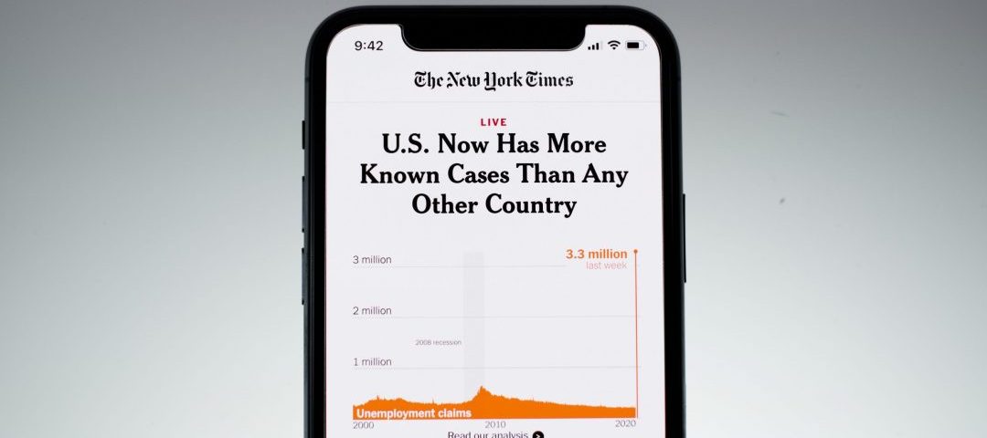 Cell phone displaying news article regarding COVID cases