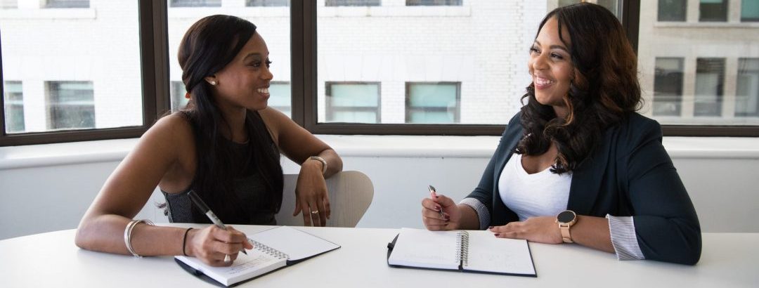 Image of two women collaborating at an office table