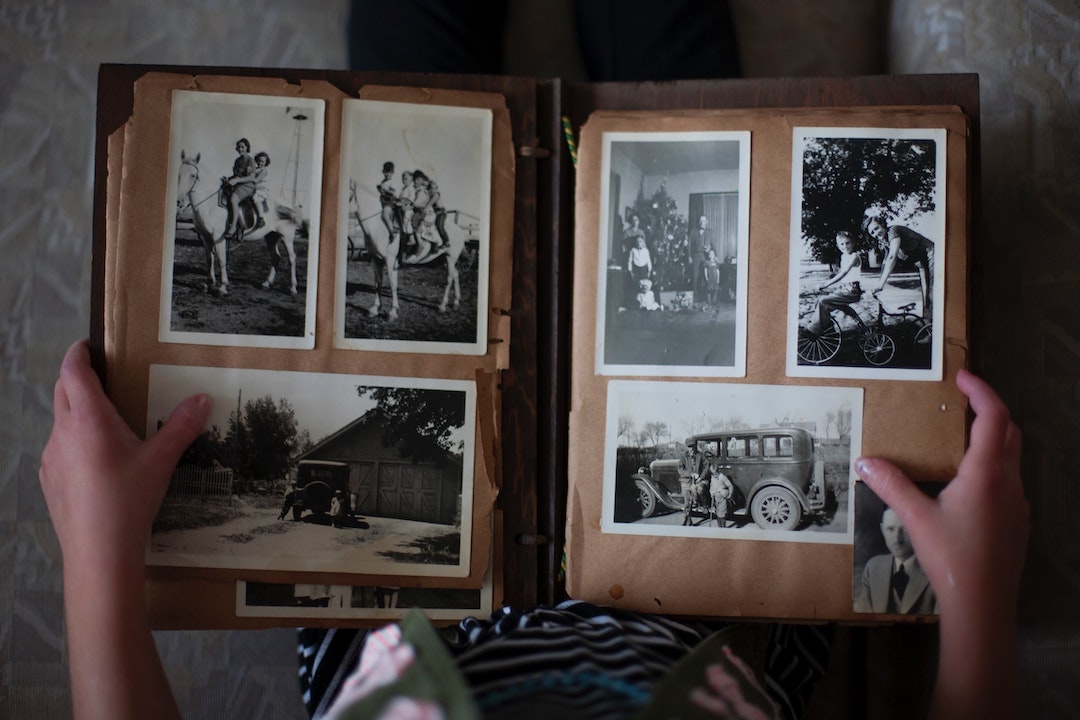 A person looking at historical photos in a family album