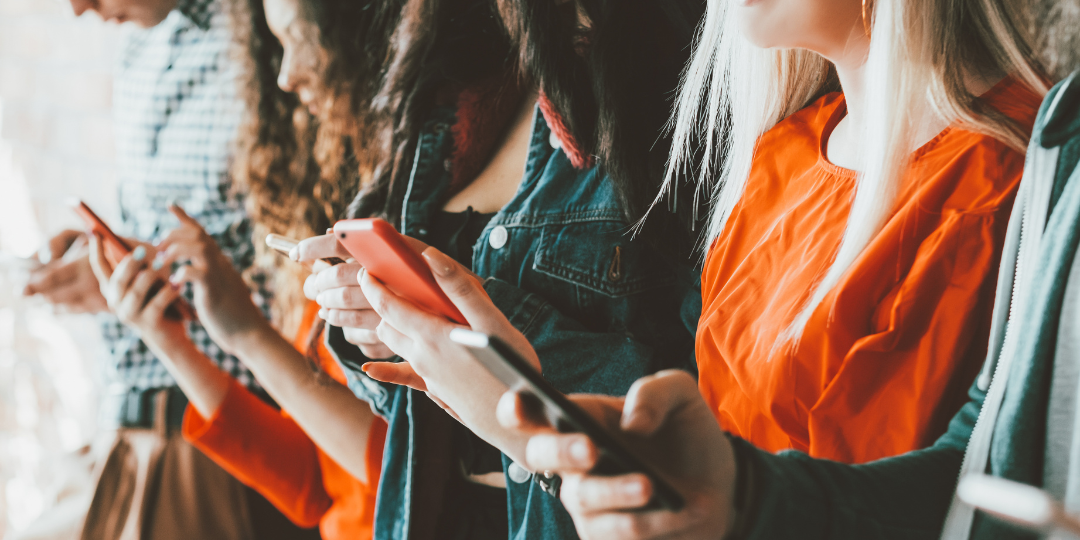 A group of people holding phones